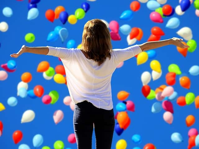 woman with outstretched arms happy